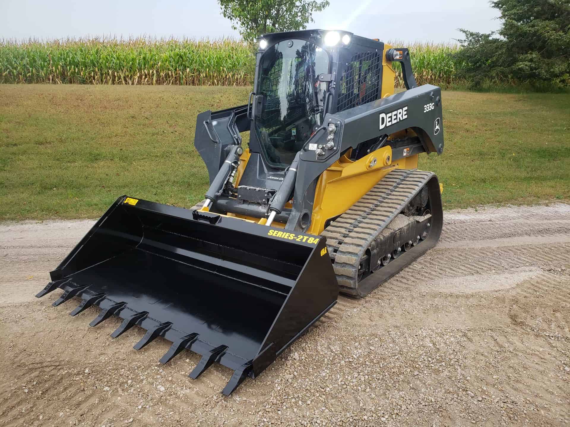 Skid steer loader with Stinger tooth bucket attachment for excavation and material handling on job sites