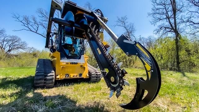Stinger Bigfoot XD skid steer trencher attachment digging trench in wooded area