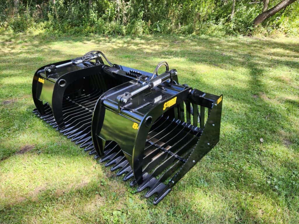 Stinger ROG skid steer rock grapple attachment for clearing rocks, brush and debris during land clearing operations