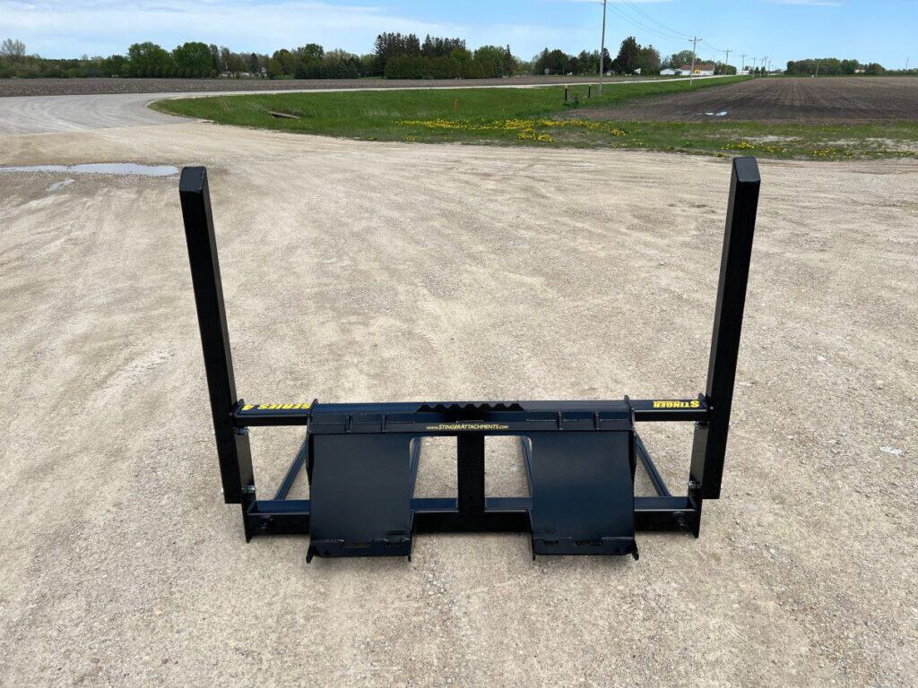 Stinger BS4 skid steer bale spear rear view showing mounting plate and stabilizer spear positioning
