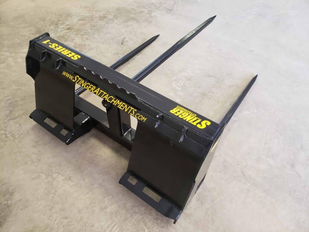 Rear angle view of Stinger BS1 skid steer bale spear with reinforced frame and dual bale spears