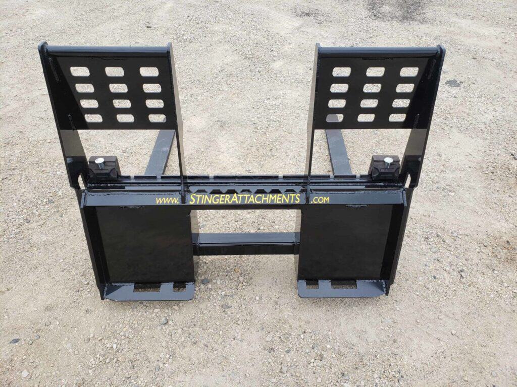 Front view of Stinger skid steer pallet fork attachment with adjustable fork tines for material handling
