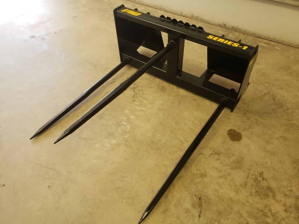 Front angle view of Stinger BS1 skid steer bale spear attachment designed for moving round hay bales
