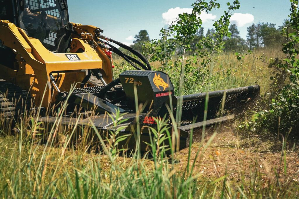 Brush Wolf extreme duty open front skid steer brush cutter cutting heavy brush and small trees