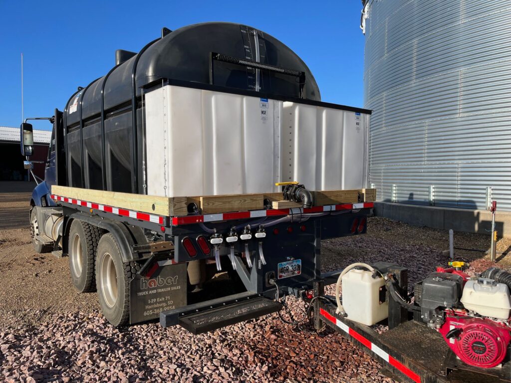 Semi tractor tender truck with ECHO SS Super Skid removable flatbed carrying agricultural nurse tanks