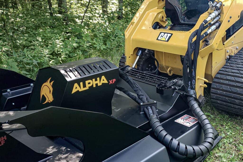 Brush Wolf Alpha Series skid steer brush cutter mounted on compact track loader with hydraulic connections