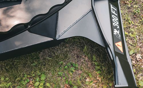Brush Wolf Alpha XP skid steer brush cutter front deflector plate designed to control debris while cutting