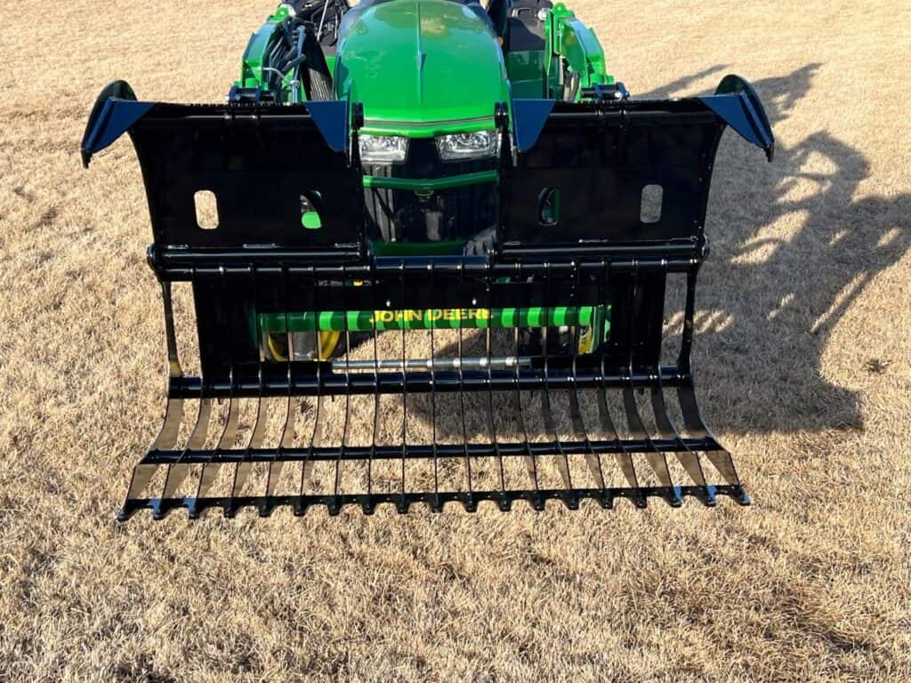 Stinger CROC compact rock grapple attachment mounted on compact tractor for rock and debris cleanup