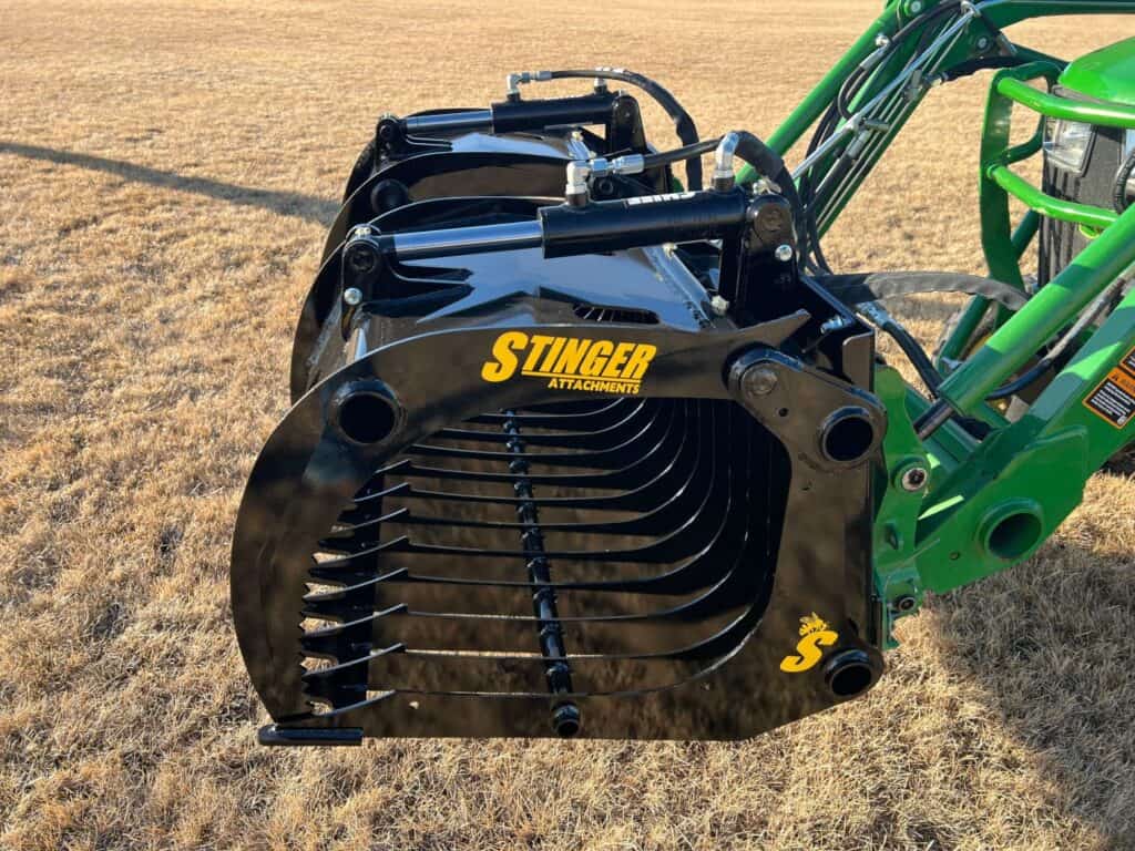 Stinger CROC compact rock grapple skid steer attachment side view showing dual grapple lids