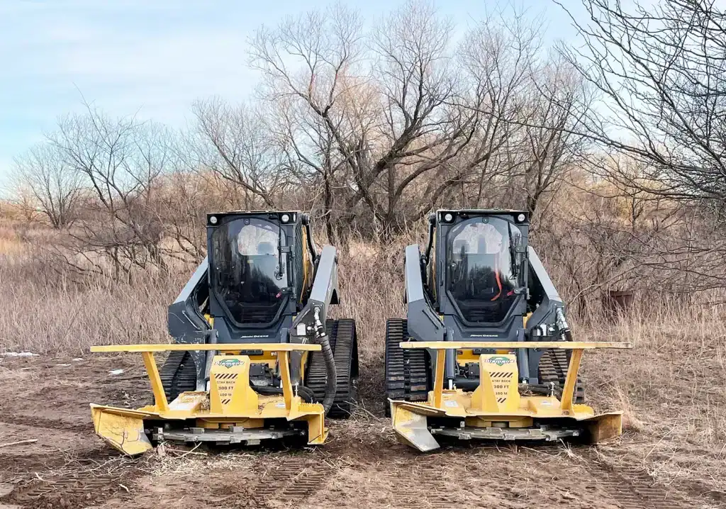 Diamond Mowers Pro X skid steer disc mulcher mounted on two skid steers showing wide coverage and jobsite versatility