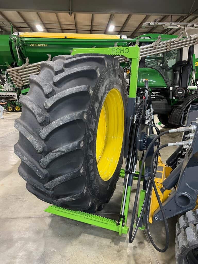 ECHO tire service bundle mounted on equipment showing tire removal and positioning in shop environment