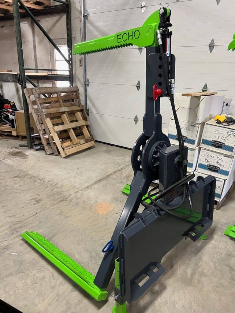 Front view ECHO OG skid steer tire handler boom and mounting tower inside fabrication shop