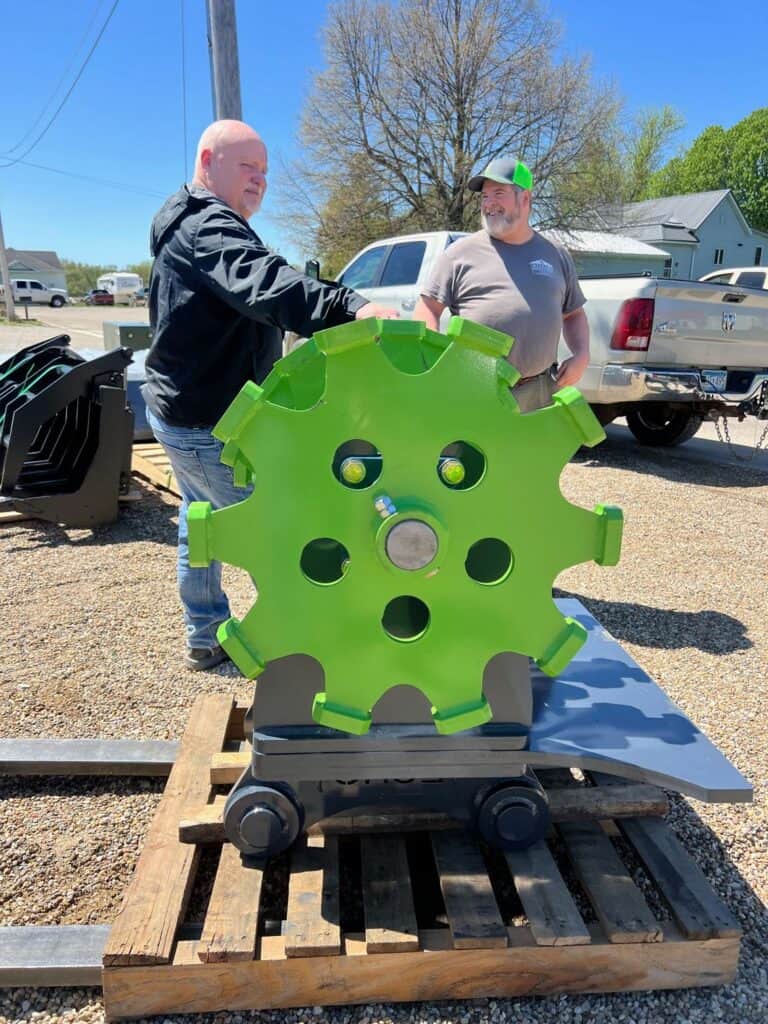 Side profile excavator compaction wheel attachment for compacting dirt and trench backfill
