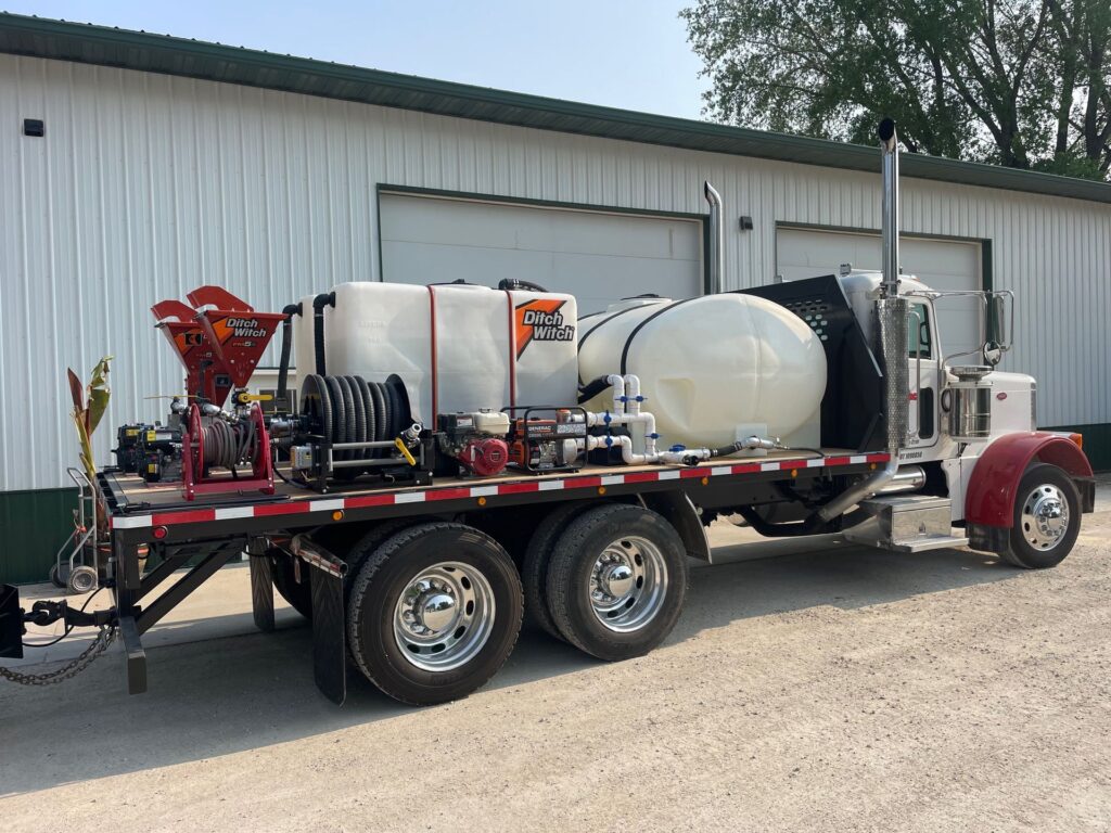 Semi tractor flatbed skid conversion carrying liquid fertilizer nurse tank setup