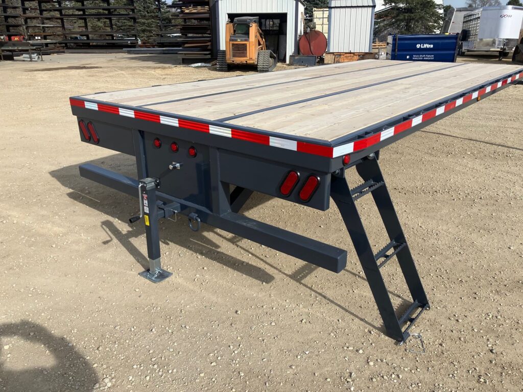 Tandem semi tractor removable flatbed skid with adjustable king pin plate