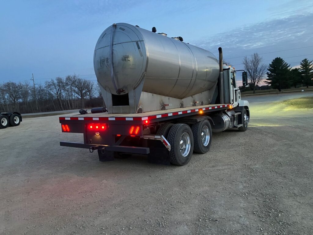 Semi tractor flatbed conversion hauling liquid fertilizer tanks for field operations