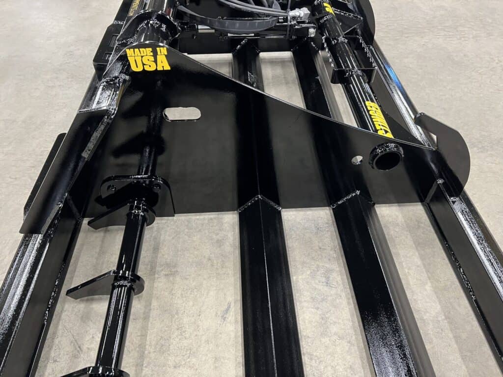 Close up of Stinger LP skid steer land plane grading blade system for leveling gravel and soil surfaces