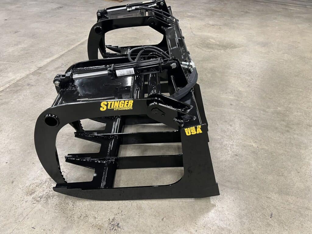 Stinger RTG tractor root grapple attachment with dual grapple clamps for debris and brush removal