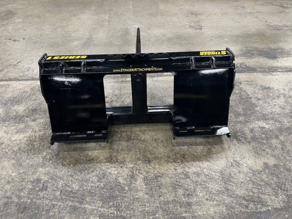 Back view of Stinger BSS skid steer bale spear attachment designed for handling round hay bales in agricultural operations