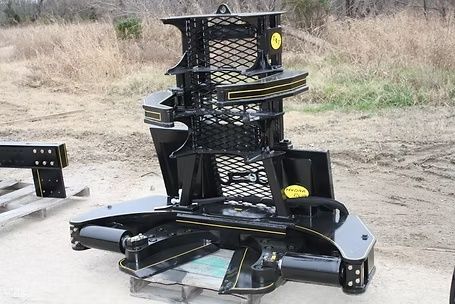 M&M Hydra Clip 16 inch tree shear attachment shown from front on gravel lot