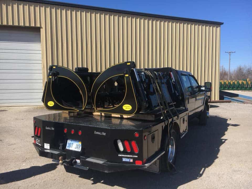M&M Hydra Rake Extreme skid steer grapple rake attachments loaded on flatbed trailer