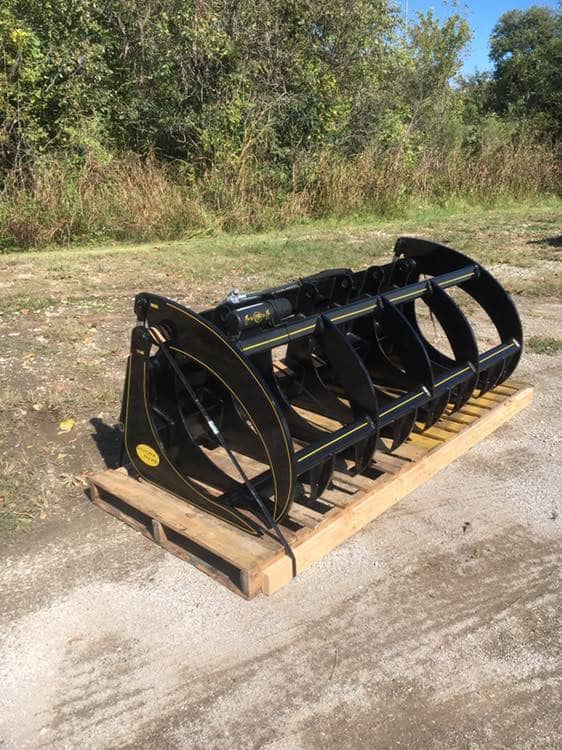 Front right view of M&M Hydra Rake Extreme skid steer attachment on pallet