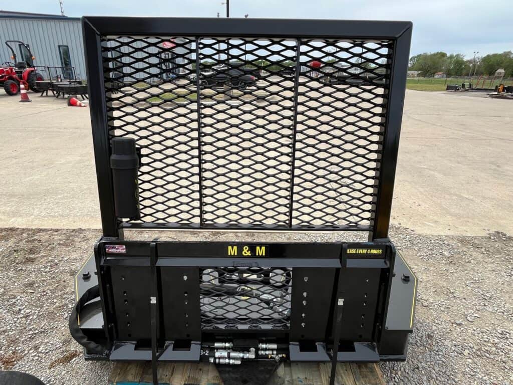 Rear view of M&M Hydra Clip 16 inch skid steer tree shear attachment with mesh guard
