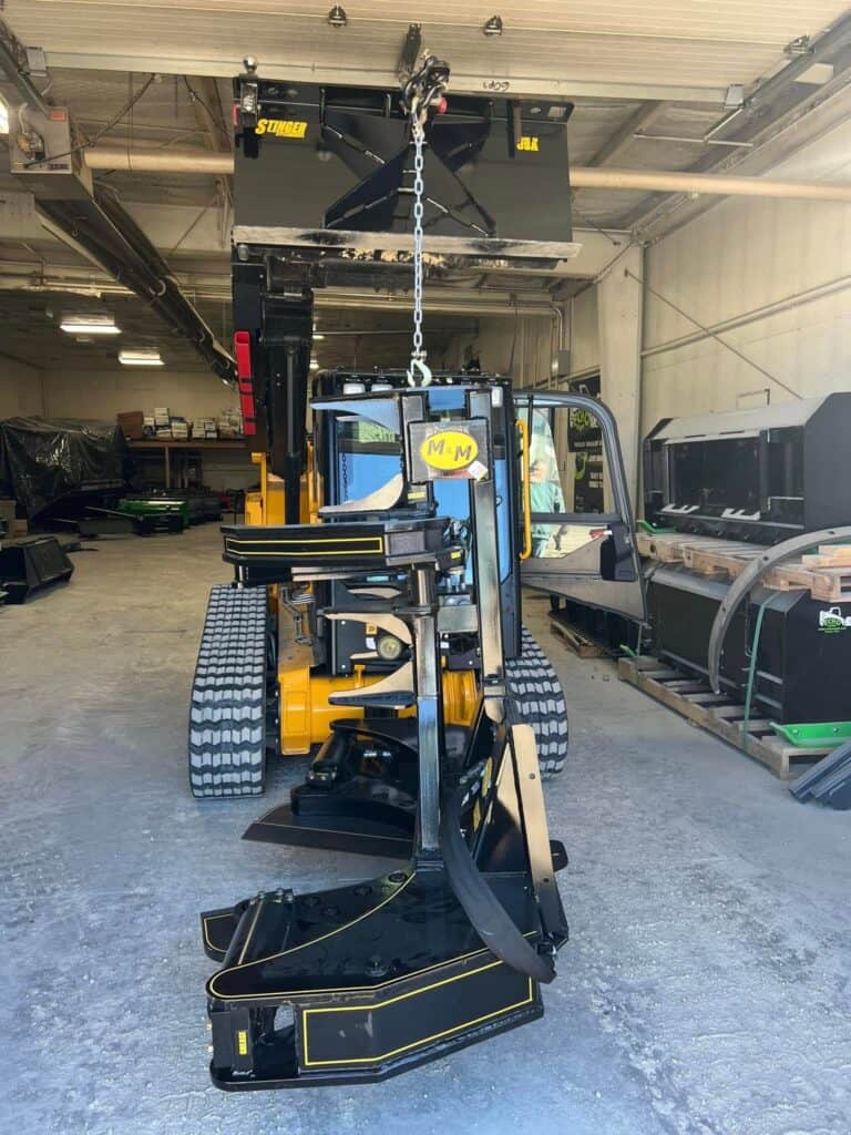 M&M Hydra Clip 16 inch tree shear attachment suspended overhead in workshop