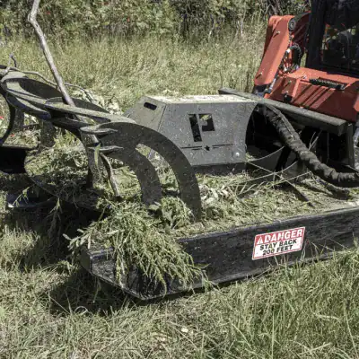 Prime Attachments direct drive skid steer brush mower underside showing blade carrier system and heavy duty cutting