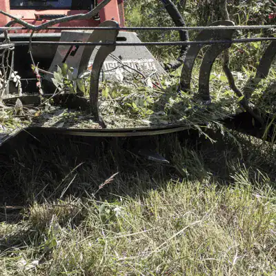 Prime Attachments direct drive skid steer brush mower cutting brush and vegetation in field conditions with high torque motor