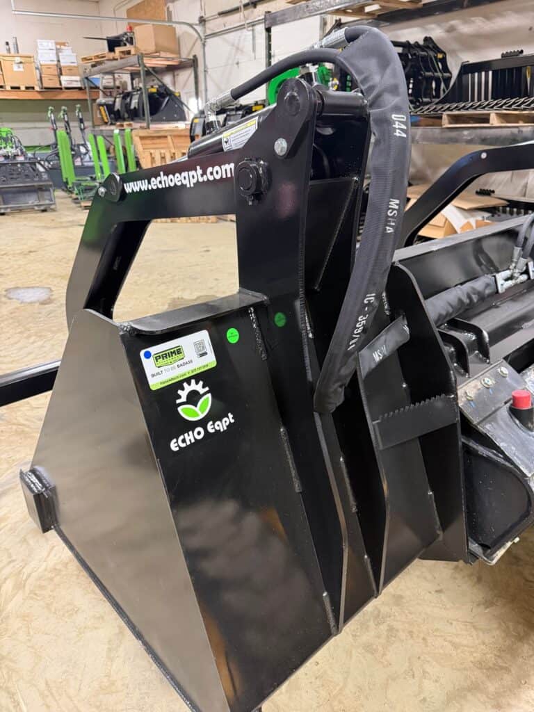 Prime Attachments high capacity skid steer grapple rear view showing grapple arms hydraulic routing and frame