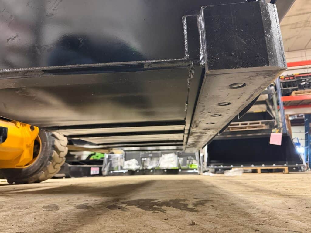 Prime Attachments high capacity skid steer grapple bottom view showing reinforced steel floor and wear surfaces