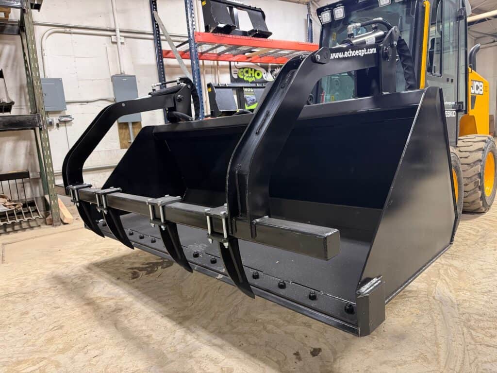 Prime Attachments high capacity skid steer grapple mounted on skid steer showing front bucket and grapple arms