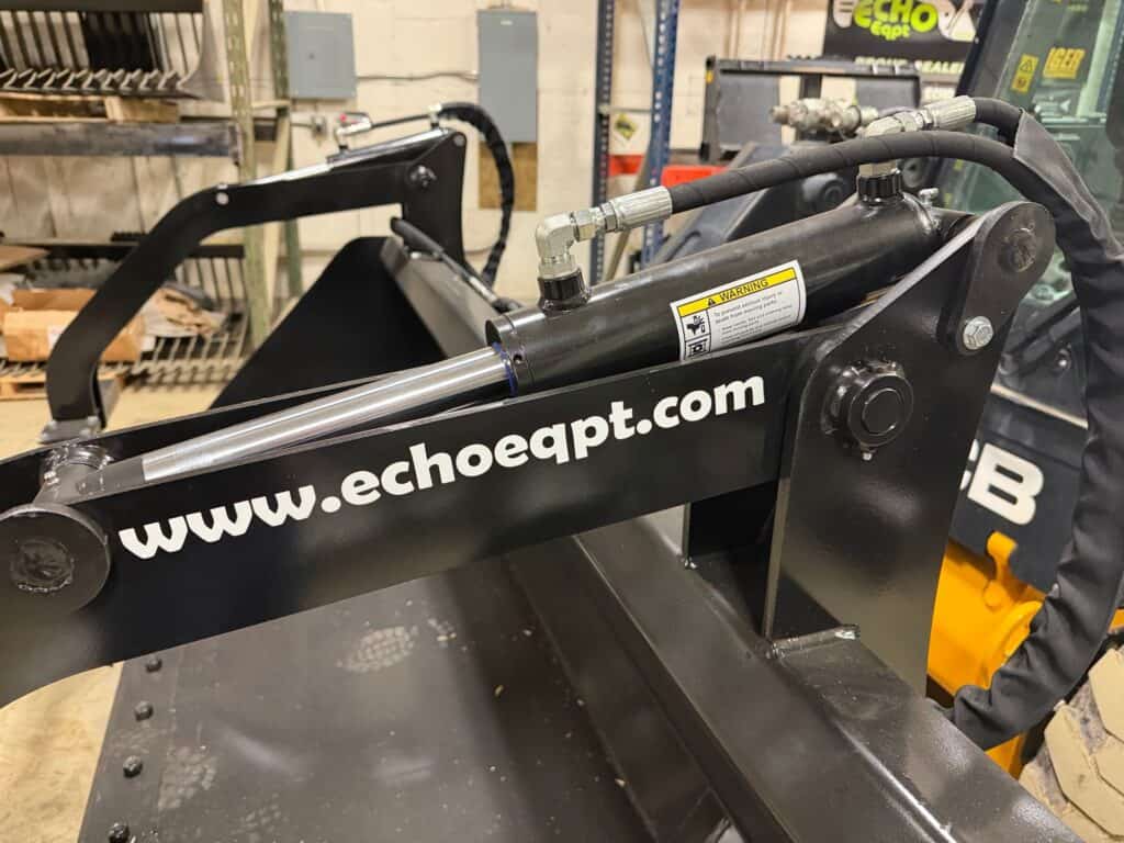Prime Attachments high capacity skid steer grapple with Echo Equipment branding on frame and hydraulic lines