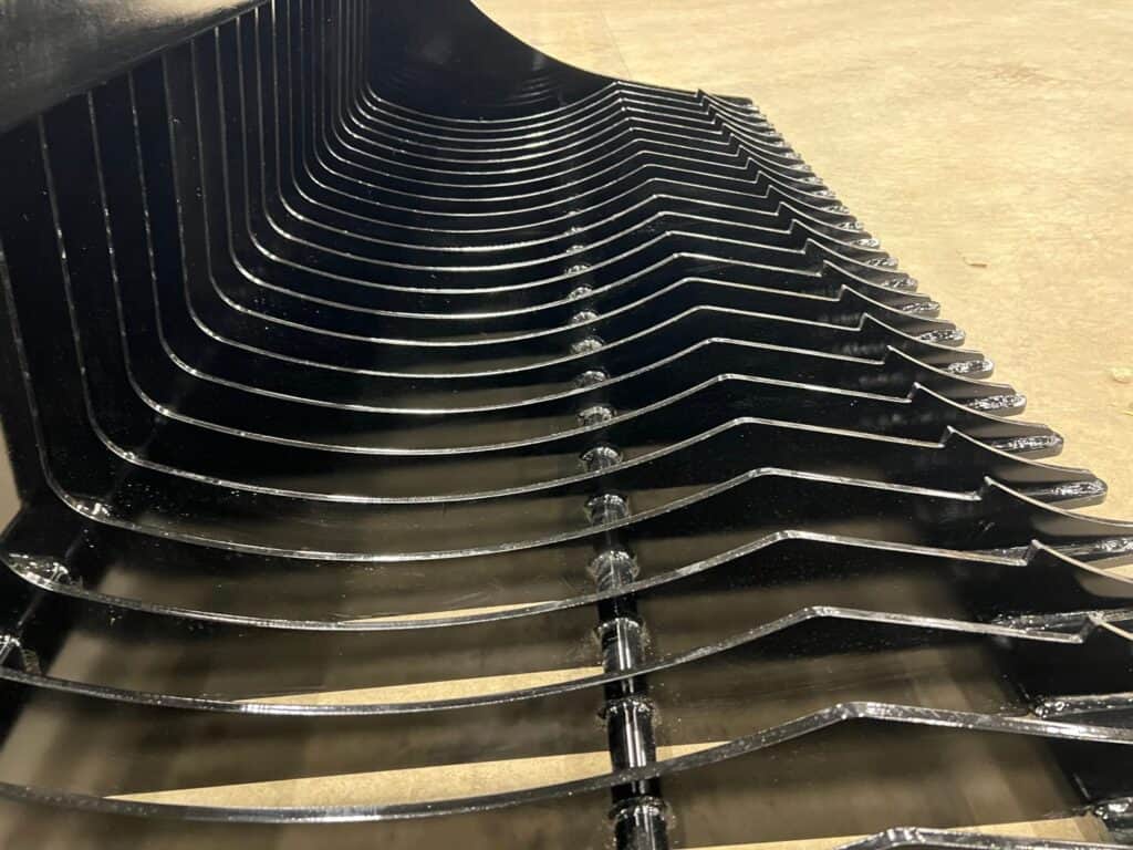 Stinger RK skid steer rock bucket close up of tine spacing showing precision sifting and debris separation design