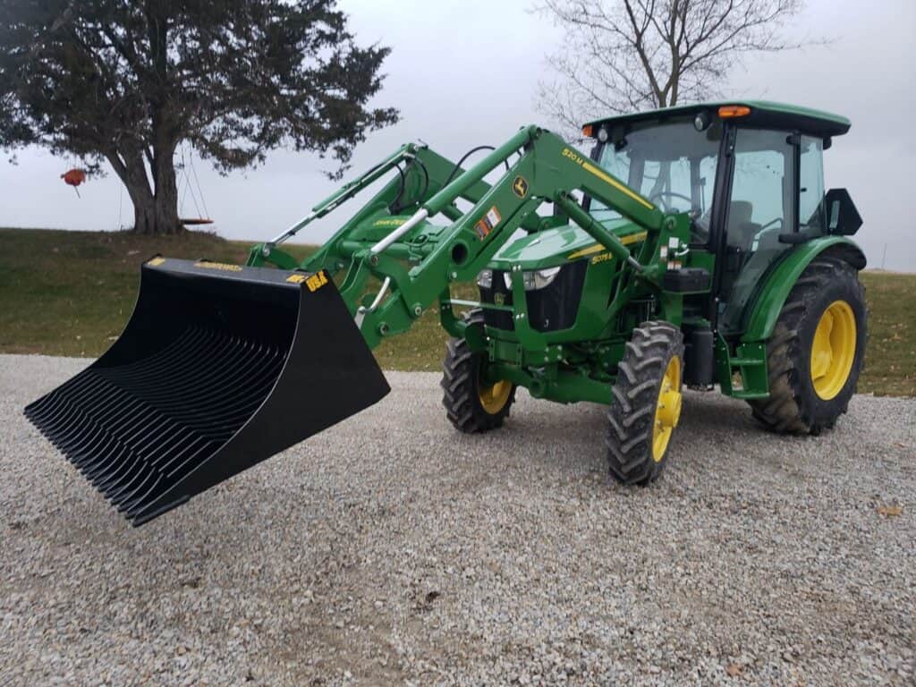 Stinger RK rock bucket mounted on tractor left view showing large capacity bucket for handling rocks and soil