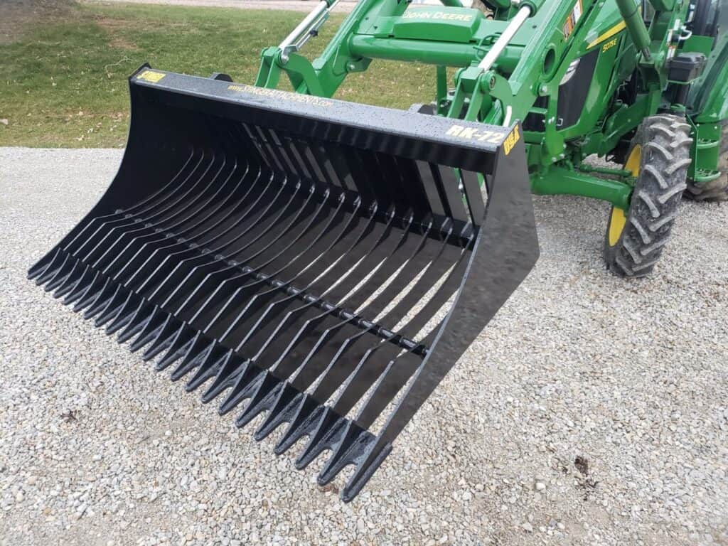 Stinger RK rock bucket mounted on tractor left view showing large capacity bucket for handling rocks and soil