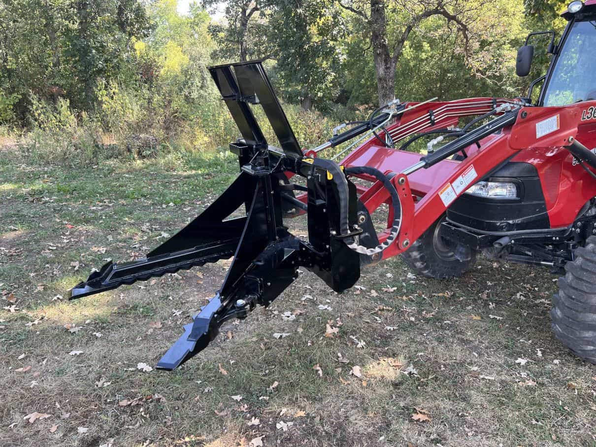 Stinger STP tree puller attached to tractor pulling small trees demonstrating aggressive teeth and root extraction power
