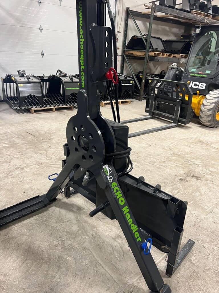 ECHO OG skid steer tire handler attachment mounted on skid steer inside equipment warehouse