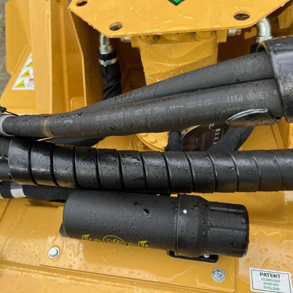 Close up of hydraulic hoses and fittings on Diamond Mowers SK skid steer disc mulcher attachment frame