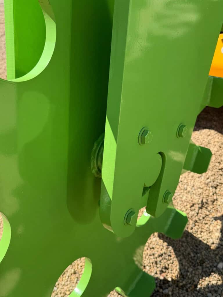 Close-up of the pivot arm, bolts and heavy steel construction on the ECHO 48 inch skid steer compaction wheel