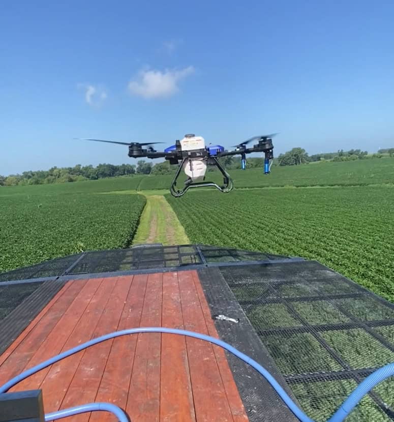 Agricultural drone taking off in field from ECHO SS Drone Skid drone launch platform system