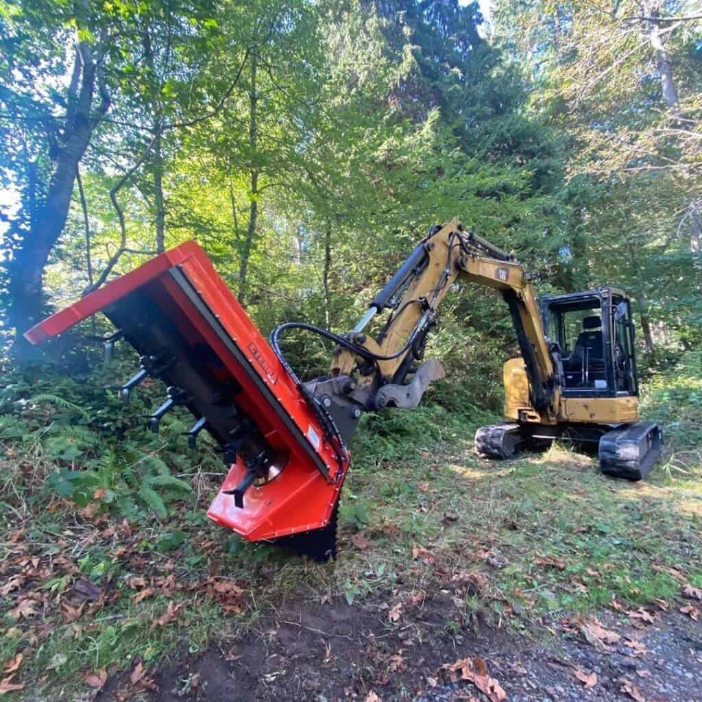 Eterra EX-40 excavator flail mower attachment operating on excavator arm for roadside and ditch mowing