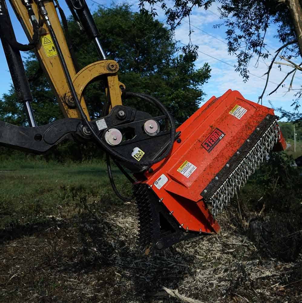 Eterra EX-30 excavator flail mower mounted with thumb saddle showing secure attachment and stable operation