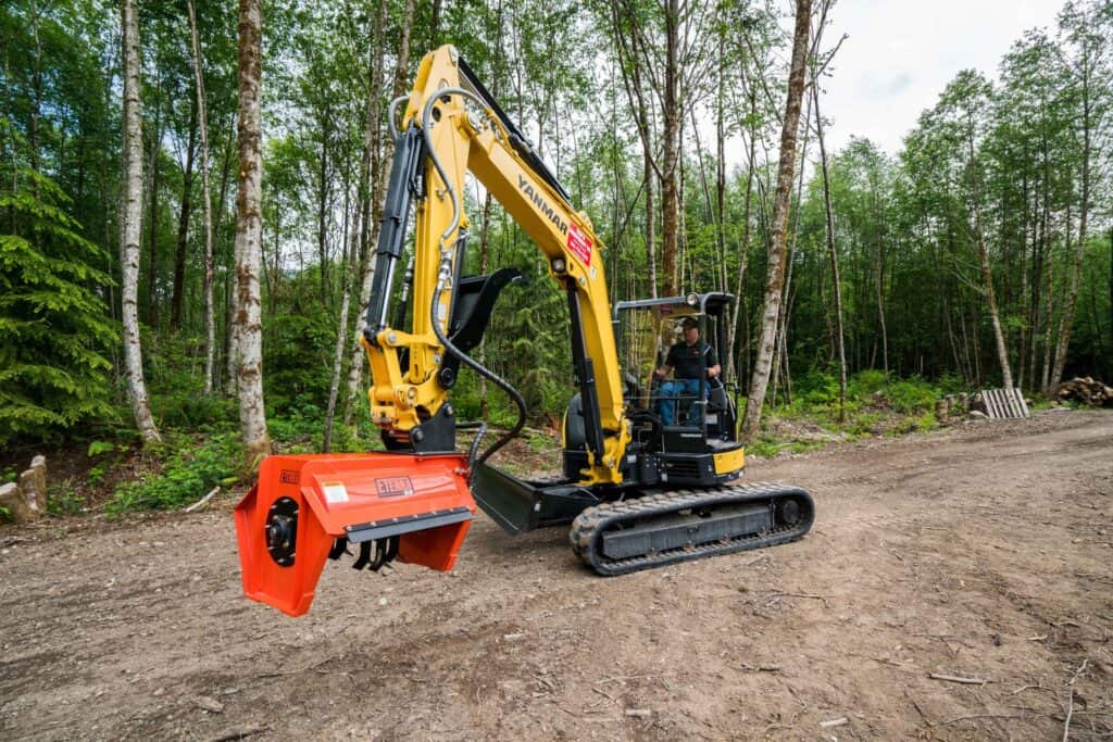 Mini excavator with Eterra EX30 brush mower clearing brush on forest trail – hydraulic excavator mowing attachment
