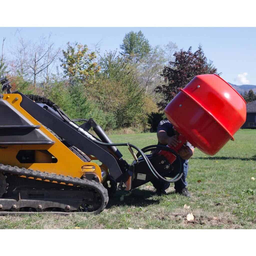 Mini skid steer operating Eterra auger attachment with concrete mixer bowl for on site concrete mixing
