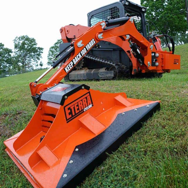 Eterra Raptor boom arm mounted on skid steer with rotary mower showing slope mowing and vegetation control