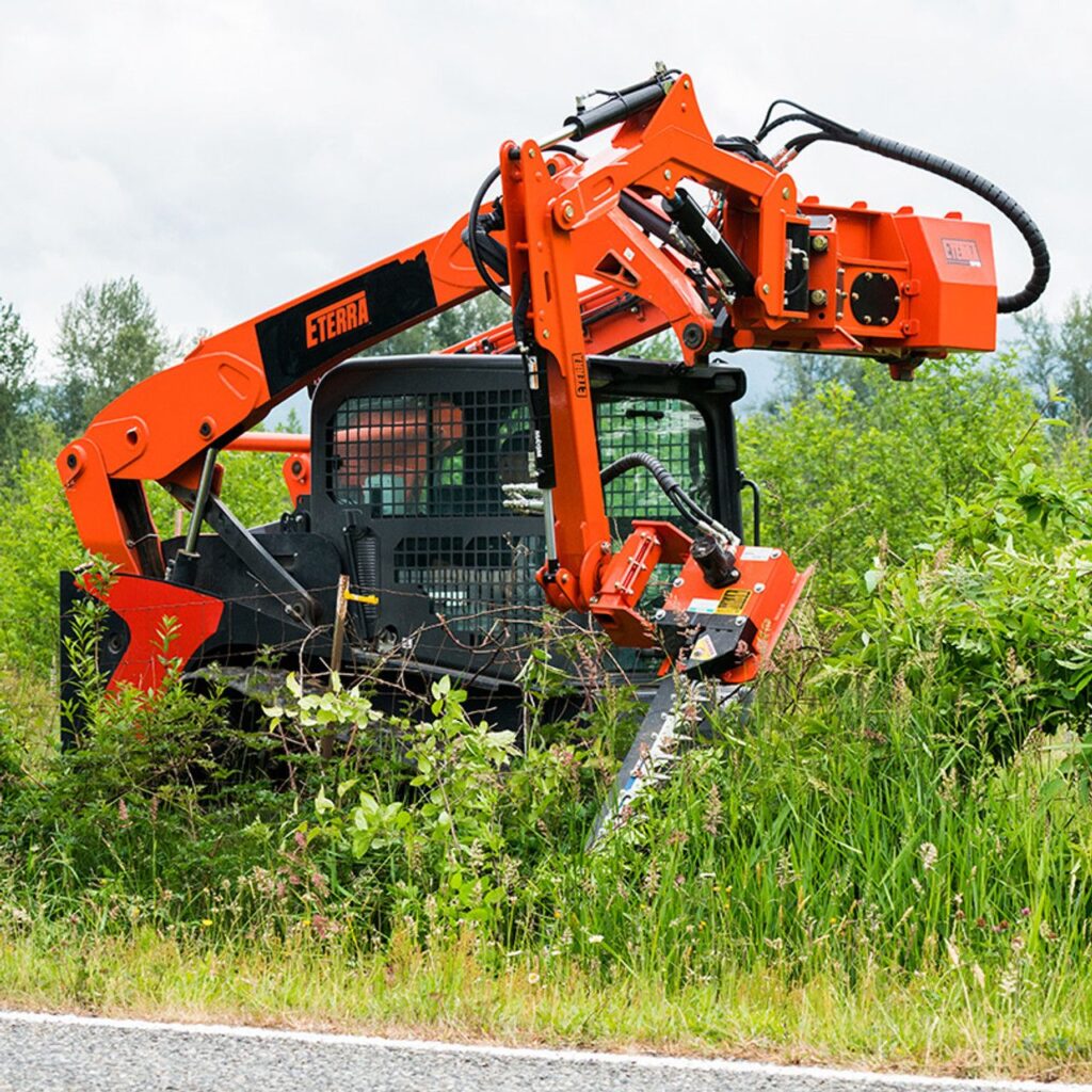 Eterra Raptor skid steer boom mower attachment extended for roadside and ditch mowing