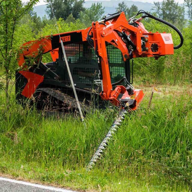 Eterra Raptor boom arm with 5 foot sickle bar mower cutting brush showing compact reach and precision trimming