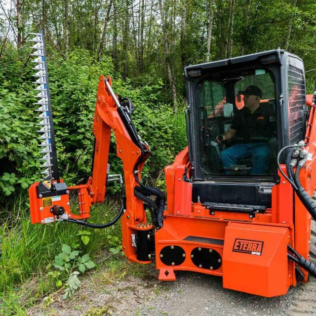 Eterra Raptor boom arm with vertical sickle bar trimming roadside vegetation showing clean cutting performance